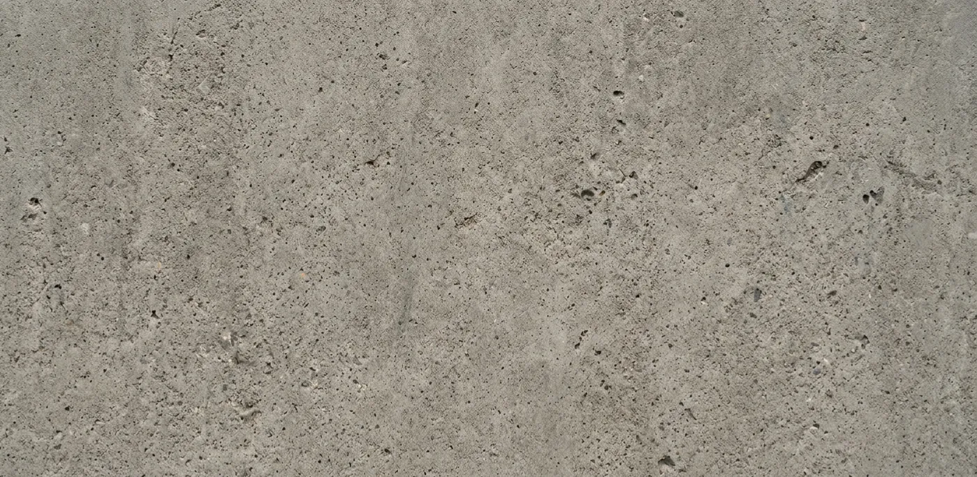 A gray concrete wall, showcasing a smooth and sturdy surface typical of concrete construction.